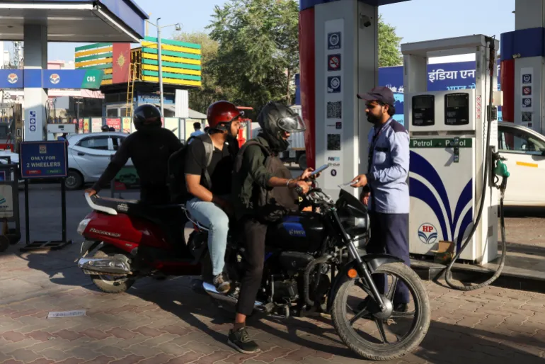 A man pays after refuelling his bike at a fuel station in New Delhi, India, March 6, 2026. REUTERS/Bhawika Chhabra