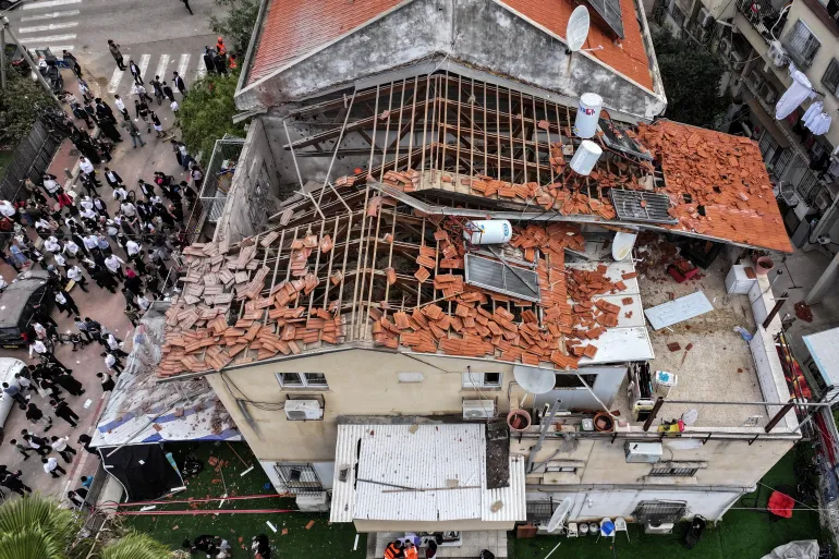 A drone view of people gathering at the site of damage in a residential neighbourhood following Iranian missile barrages in central Israel, amid the U.S.-Israel conflict with Iran, in Bnei Brak, Israel, March 31, 2026. REUTERS/Roei Kastro ISRAEL OUT. NO COMMERCIAL OR EDITORIAL SALES IN ISRAEL TPX IMAGES OF THE DAY
