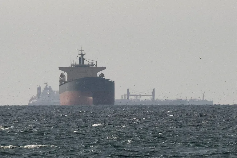 FILE PHOTO: Cargo ships in the Gulf, near the Strait of Hormuz, as seen from northern Ras al-Khaimah, near the border with Oman’s Musandam governance, amid the U.S.-Israeli conflict with Iran, in United Arab Emirates, March 11, 2026. REUTERS/Stringer/File Photo