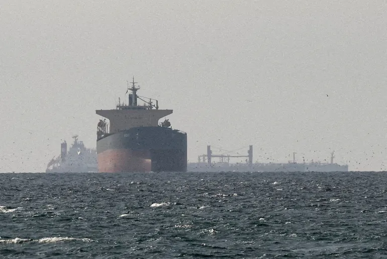 FILE PHOTO: Cargo ships in the Gulf, near the Strait of Hormuz, as seen from northern Ras al-Khaimah, near the border with Oman’s Musandam governance, amid the U.S.-Israeli conflict with Iran, in United Arab Emirates, March 11, 2026. REUTERS/Stringer/File Photo