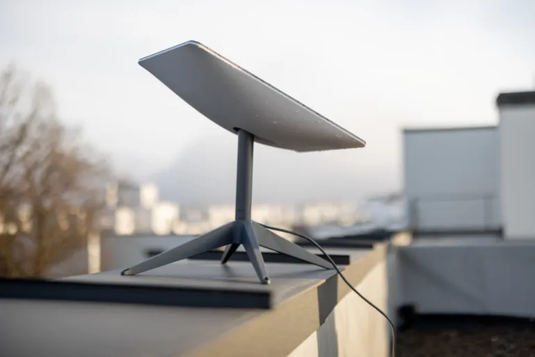 LVIV, UKRAINE - January, 2023: Starlink satellite dish, internet constellation operated by SpaceX, installed on roof of residential building on sunny day