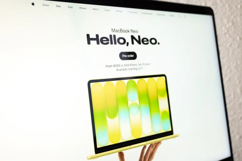 Mexico city, mexico, 03 04 2026, hands holding a new macbook neo laptop on a product launch webpage