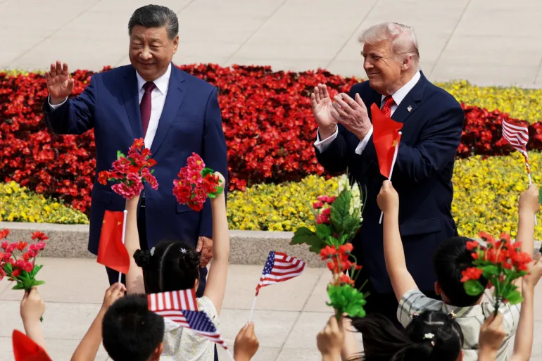 BEIJING, CHINA - MAY 14: U.S. President Donald Trump and Chinese President Xi Jinping attend a welcome ceremony at the Great Hall of the People on May 14, 2026 in Beijing, China. President Trump is meeting with President Xi Jinping in Beijing to address the Iran conflict, trade imbalances, and the Taiwan situation while establishing new bilateral boards for economic and AI oversight. (Photo by Alex Wong/Getty Images)