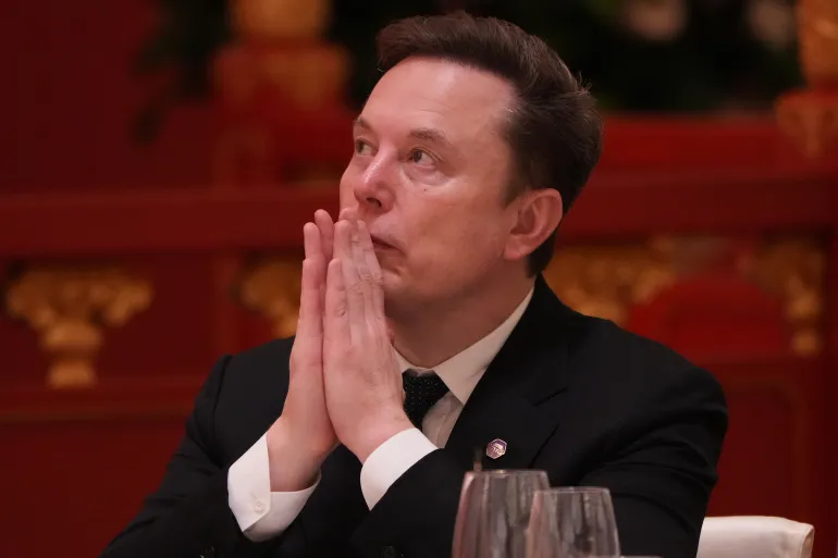 Elon Musk listens to the speech of Chinese President Xi Jinping during a state dinner with President Donald Trump at the Great Hall of the People on Thursday May 14, 2026, in Beijing. (AP Photo/Mark Schiefelbein)