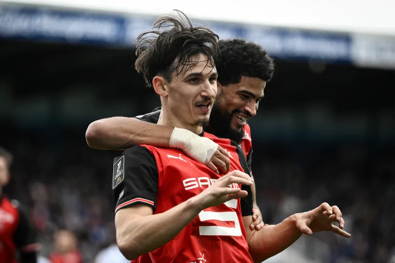 Rennes' French forward #9 Esteban Lepaul (C) is congratulated by teammate midfielder #45 Mahdi Camara after scoring a goal during the French L1 football match between Auxerre and Rennes at Stade Abbe-Deschamps in Auxerre, central France, on February 22, 2026.