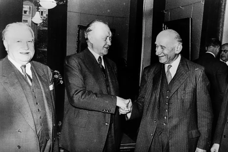 French Foreign Minister Robert Schuman (2nd R) and German Chancellor Konrad Adenauer (2nd L) shake hands in presence of Luxembourgish politician Josep Bech (L) and Italian Prime Minister Alcide De Gasperi (R) in Luxemburg in September 1952. On 8 September 1952, German Chancellor Konrad Adenauer chaired the first meeting of the ECSC Special Council of Ministers in Luxembourg and delivered an opening speech at which he described the precise role of the institution. (Photo by AFP via Getty Images)