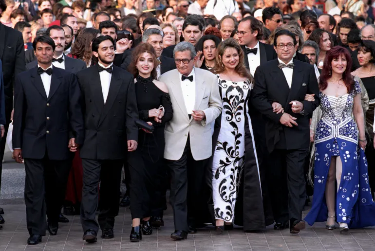 Egyptian director Youssef Chahine (C) arrives with cast members including actress Laila Eloui (3rd R) and actor Nour El Cherif (2nd R) for the screening of their film "Al Massir", May 15. Chahine's film is screened in competition for the [Palme d'Or] as the 50th Cannes Film Festival continues.