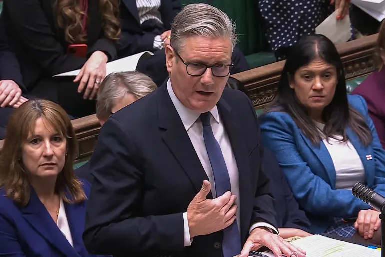 This video grab taken from footage broadcast by the UK Parliament's Parliamentary Recording Unit (PRU) shows Britain's Prime Minister Keir Starmer (C) speaking during the weekly session of Prime Minister's Questions (PMQs) in the House of Commons in London on April 22, 2026.