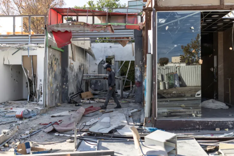 A Palestinian worker walks past shops he has demolished, ahead of the arrival of an Israeli army demolition team, in the Israeli-occupied Palestinian West Bank town of al-Eizariya, bordering East Jerusalem on May 10, 2026.