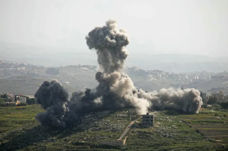 TOPSHOT - Smoke rises from the site of an Israeli airstrike that targeted the southern Lebanese village of Deir El Zahrani on May 13, 2026.