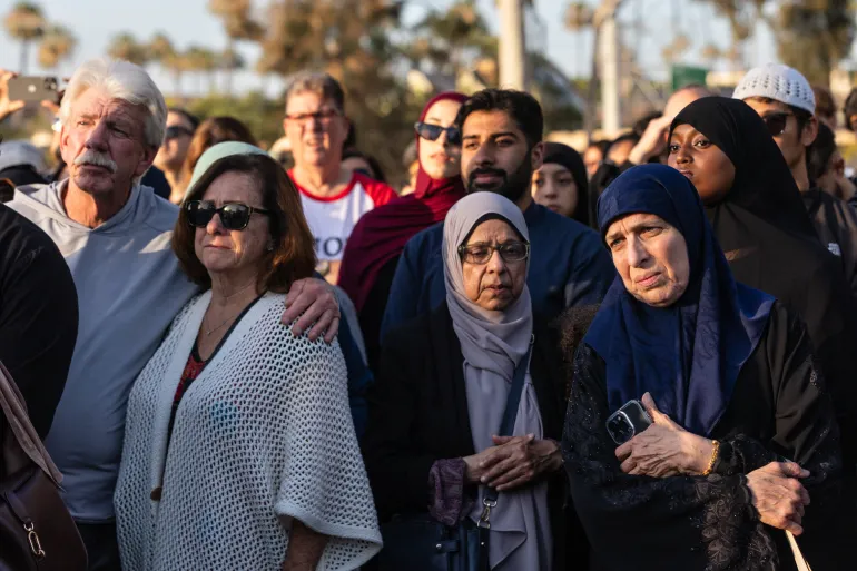 Community members gather at a vigil for victims and families of a shooting at the Islamic Center of San Diego, California, on May 19, 2026, a day after the attack.