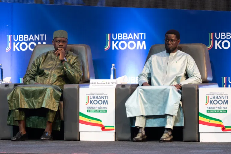 (FILES) Senegalese Prime Minister Ousmane Sonko (L) and Senegalese President Bassirou Diomaye Faye (R) attend the opening of the official ceremony of the presentation of the economic and social recovery plan by the head of government at the Grand Theatre in Dakar on August 1, 2025.