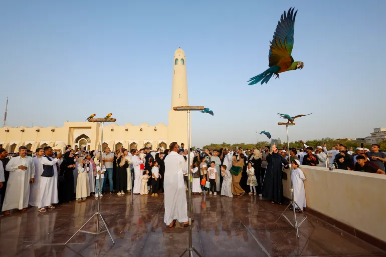 EDITORS NOTE: Graphic content / Muslims gather in front of the Imam Muhammad ibn Abd al-Wahhab Mosque in Doha on May 27, 2026, to celebrate the first day of Eid al-Adha, the Feast of Sacrifice, marking the end of the annual Hajj pilgrimage to Mecca and commemorating the Prophet Abraham’s willingness to sacrifice his son in obedience to God. (Photo by Karim JAAFAR / AFP)