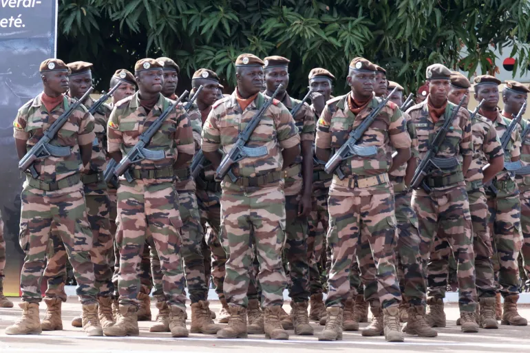 Soldiers wait for the start of the funeral for Mali's former defense minister Sadio Camara at the Military Engineering Parade Ground in Bamako, Mali, Thursday, April 30, 2026. (AP Photo/Boubacary Bocoum)