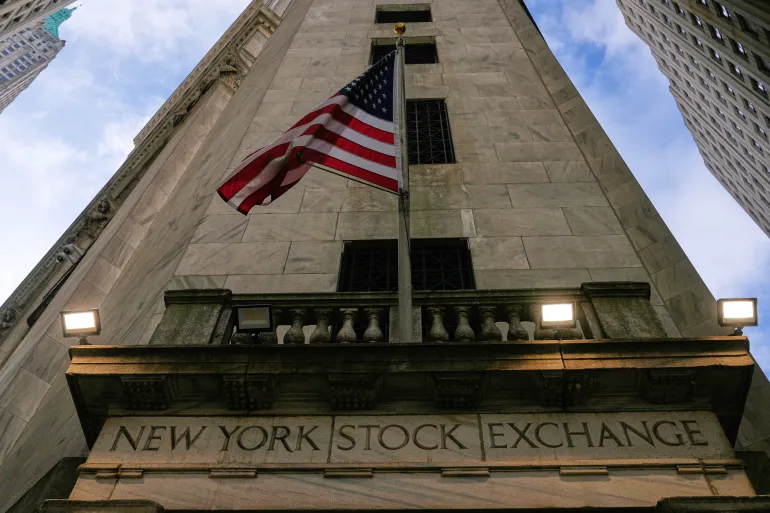 FILE - An American flag is displayed over an entrance to the New York Stock Exchange in New York, Thursday, Feb. 12, 2026. (AP Photo/Seth Wenig, File)