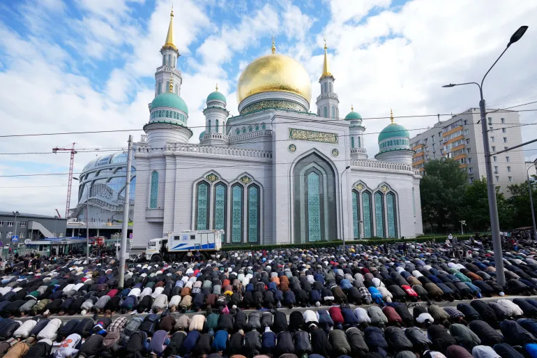 Muslims offer Eid al-Adha prayers outside the Moscow Cathedral Mosque in Moscow, Wednesday, May 27, 2026. (AP Photo/Pavel Bednyakov)