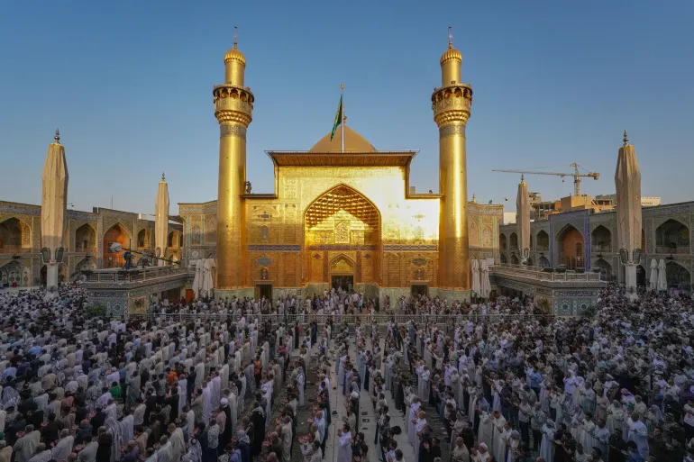 Iraqi Shiite Muslims gather for an Eid al-Adha prayer at the shrine of Imam Ali in Najaf, Iraq, Wednesday, May 27, 2026. (AP Photo/Anmar Khalil)