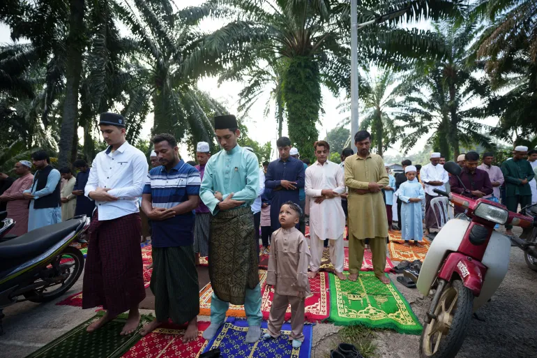 Rohingya muslims perform morning prayer marking the Eid al-Adha outside a mosque in Klang, outskirt of Kuala Lumpur, Malaysia, Wednesday, May 27, 2026. (AP Photo/Vincent Thian)