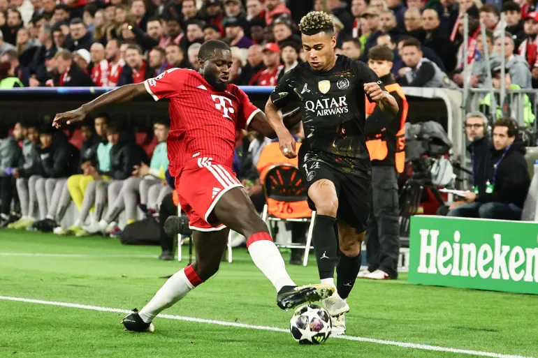 epa12937151 Dayot Upamecano (L) of Bayern Munich in action against Desire Doue of PSG during the UEFA Champions League semi-final, second leg soccer match between Bayern Munich and Paris Saint-German, in Munich, Germany, 06 May 2026. EPA/RONALD WITTEK