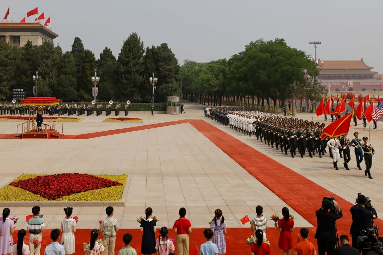 epa12955759 Chinese honor guard members march during a welcome ceremony for US President Donald Trump at the Great Hall of the People in Beijing, China, 14 May 2026. US President Trump is in Beijing for a high-stakes state visit running through 15 May, marking his first return to the mainland since 2017. EPA/MAXIM SHEMETOV / POOL