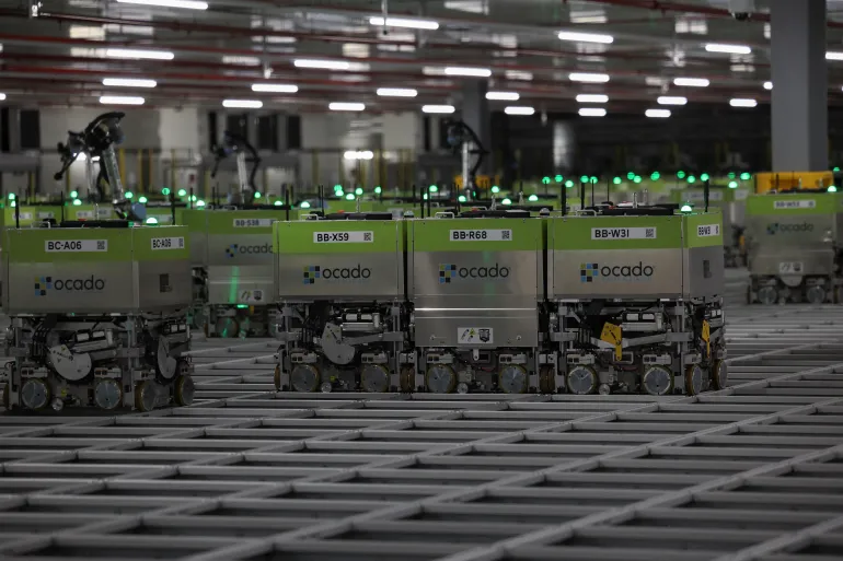 LUTON, ENGLAND - JULY 2: automated packing robots are shown during a visit by British Prime Minister Rishi Sunak to the Ocado distribution centre at a Conservative general election campaign event on July 2, 2024 near Luton, England. Labour currently holds a 20-point lead over the Conservatives, according to the latest Ipsos poll. Just over a third of voters say they may change their mind before polling day. (Photo by Phil Noble-WPA Pool/Getty Images)