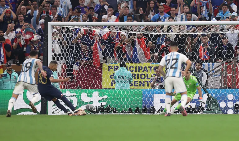 LUSAIL CITY, QATAR - DECEMBER 18: Kylian Mbappe of Francescores to make it 3-3 from the penalty spot in extra time during the FIFA World Cup Qatar 2022 Final match between Argentina and France at Lusail Stadium on December 18, 2022 in Lusail City, Qatar. (Photo by Julian Finney/Getty Images)