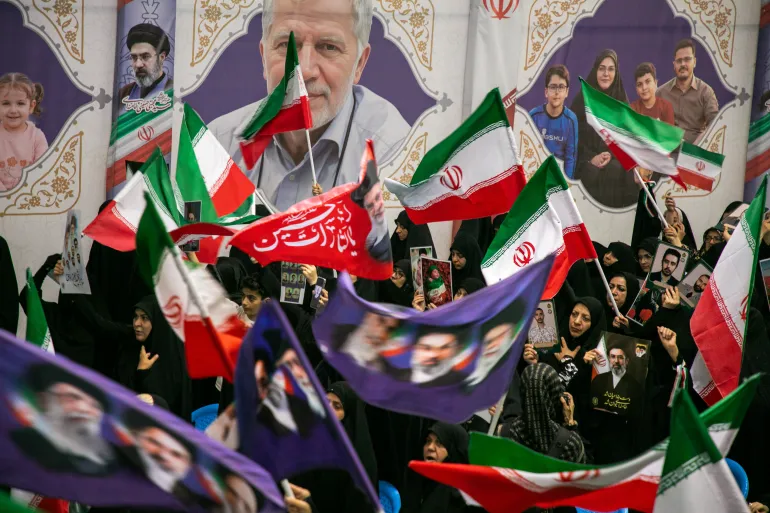 TEHRAN, IRAN - MAY 24: People hold portraits of the dead at the Imam Khomeini Mosalla Mosque to commemorate those killed in the current US-Israeli war as well as previous wars on May 24, 2026 in Tehran, Iran. President Donald Trump said a peace deal with Iran has been largely negotiated with details, including the reopening of the Strait of Hormuz, to be announced soon. (Photo by Majid Saeedi/Getty Images)