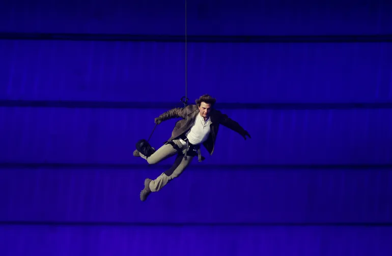 PARIS, FRANCE - AUGUST 11: Actor Tom Cruise jumps from the roof of the Stade de France during the Closing Ceremony of the Olympic Games Paris 2024 at Stade de France on August 11, 2024 in Paris, France. (Photo by Fabrizio Bensch- Pool/Getty Images)