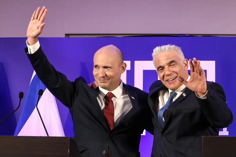 Former Israeli Prime minister Naftali Bennett and Israeli opposition leader Yair Lapid gesture as they announce their political union ahead of this year's general election, the new party will be called Together, in Herzliya, Israel April 26, 2026. REUTERS/ Gideon Markowicz ISRAEL OUT. NO COMMERCIAL OR EDITORIAL SALES IN ISRAEL TPX IMAGES OF THE DAY