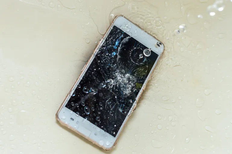 Phone in the water. Concept broken phone. Smartphone repair concept