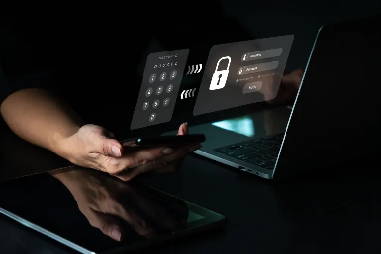 A woman with a mobile phone and a laptop computer has a safe account. Hacking a Phishing mobile phone with a password to get access to a smartphone, internet security issues.