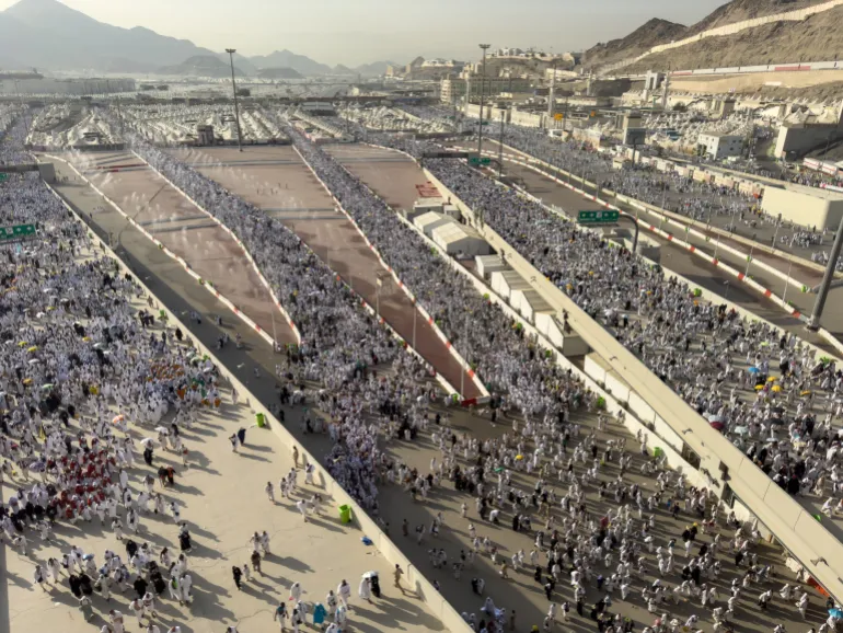 Mecca, Saudi Arabia - June 16, 2024: A group of Hajj pilgrims walk in the city of Mina to perform the ritual of stoning the devil at Jamarat. Around 4 million people perform the Hajj every year.