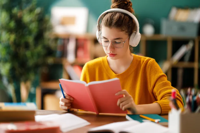 Kid at school. Child is learning in the class or doing homework.