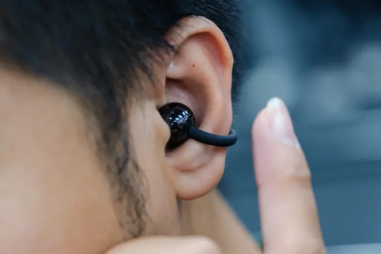 HO CHI MINH CITY, VIETNAM, MARCH 7 2026 – Huawei FreeClip 2 open-ear wireless earbuds with C-bridge clip design displayed on a desk setup. Editorial use only.