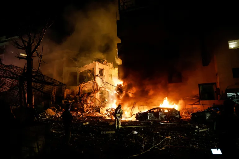 Israeli firefighters work to put out a fire on a car at the site of a projectile impact after Iran launched missiles into Israel, following Israeli and U.S. strikes on Iran, in Tel Aviv, Israel, February 28, 2026. REUTERS/Tomer Appelbaum ISRAEL OUT. NO COMMERCIAL OR EDITORIAL SALES IN ISRAEL TPX IMAGES OF THE DAY