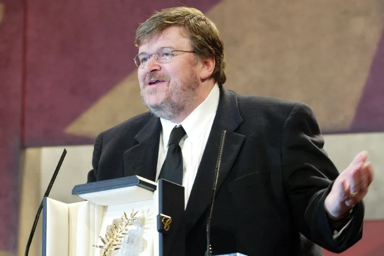 Director Michael Moore poses with his Palme d'Or for the film "Fahrenheit 9/11" (Photo by Toni Anne Barson Archive/WireImage)