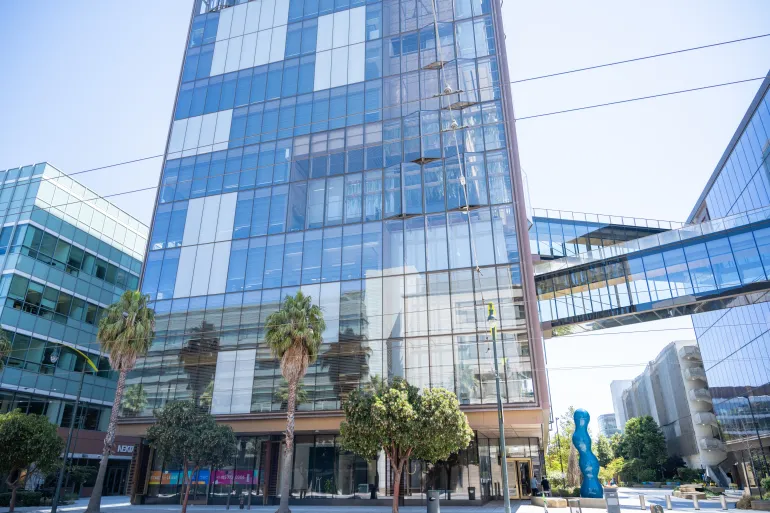 Headquarters of artificial intelligence company OpenAI with elevated glass skybridge and blue abstract sculpture on a sunny day, San Francisco, California, August 14, 2025. (Photo by Smith Collection/Gado/Getty Images)