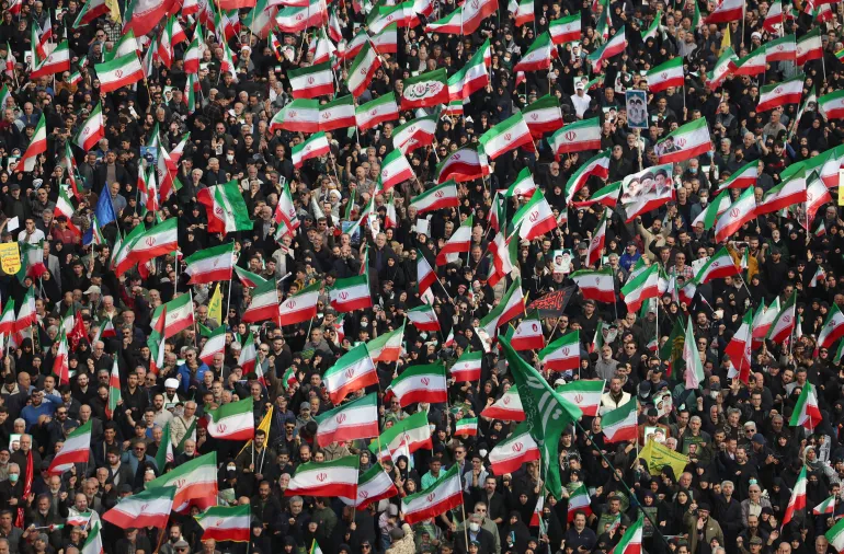 People wave Iranian flags while attending the funeral of Alireza Tangsiri, commander of the Iranian Revolutionary Guards' navy alongside others killed in US-Israeli strikes on Iran at Enghelab Square in Tehran on April 1, 2026.