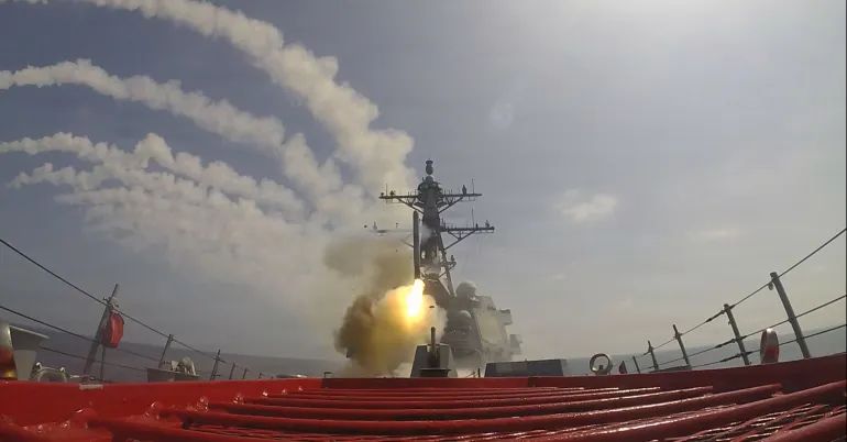 This image provided by U.S. Central Command shows the Arleigh Burke-class guided-missile destroyer USS Frank E. Petersen Jr. (DDG 121)) firing a Tomahawk Land Attack Missile (TLAM) in support of Operation Epic Fury, on Saturday, Feb. 28, 2026. (U.S. Navy via AP)
