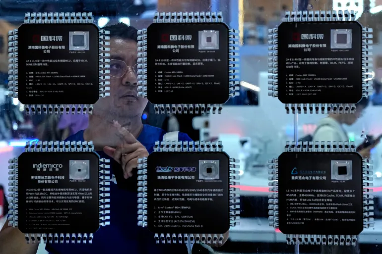 A man takes a closer look at various Chinese made chips for the automotive market showcased at the Auto China 2026, in Beijing, Saturday, April 25, 2026. (AP Photo/Andy Wong)