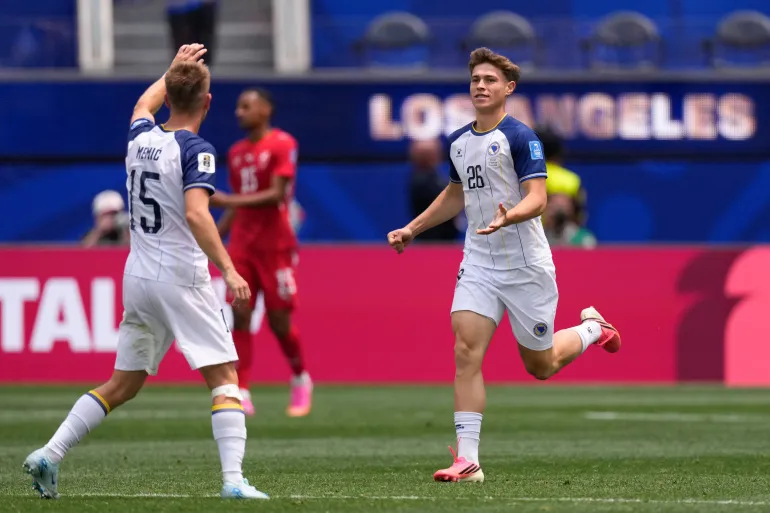 Bosnia's Ermin Mahmic, right, celebrates with teammate Amar Memic after scoring his side's first goal during the World Cup Group B soccer match between Switzerland and Bosnia in Inglewood, Calif., near Los Angeles, Thursday, June 18, 2026. (AP Photo/Mark J. Terrill)
