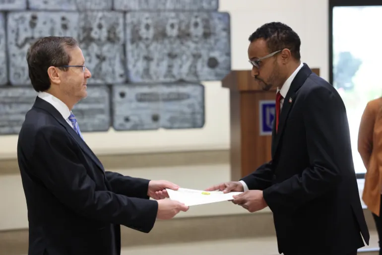 epa12970116 Somaliland Ambassador Mohamed Hagi (R) presents his diplomatic credentials to Israeli President Isaac Herzog (L), becoming Somaliland's first ambassador to a foreign country, at the Israeli president's residence in Jerusalem, 18 May 2026. EPA/ABIR SULTAN