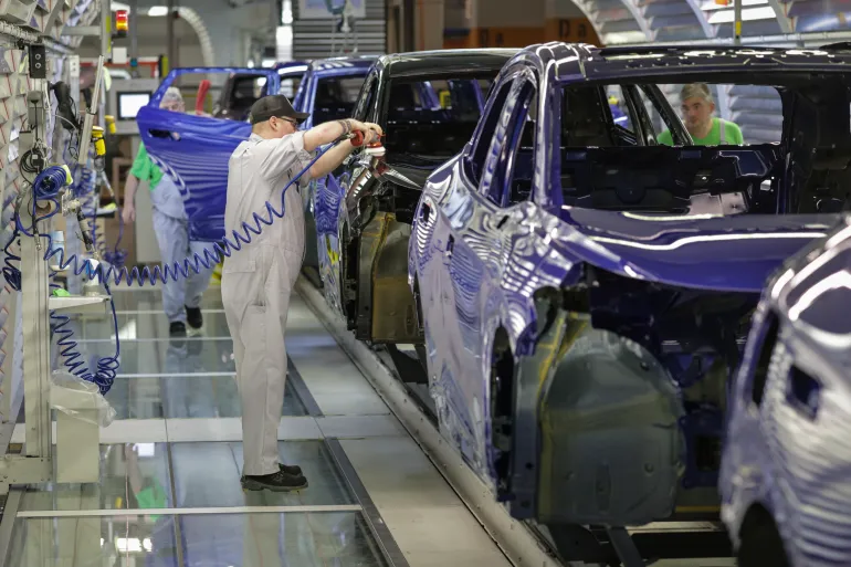 EMDEN, GERMANY - FEBRUARY 24: Volkswagen assembly worker perform final checks and corrections on ID line electric cars in the paint shop at the Volkswagen electric car factory on February 24, 2026 in Emden, Germany. Volkswagen rose in 2025 to first place in electric car sales in Europe, beating out rival Tesla. (Photo by Focke Strangmann/Getty Images)