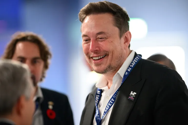 BLETCHLEY, ENGLAND - NOVEMBER 01: SpaceX, X (formerly known as Twitter), and Tesla CEO Elon Musk speaks with other delegates during day one of the AI Safety Summit at Bletchley Park on November 01, 2023 in Bletchley, England. The UK Government are hosting the AI Safety Summit bringing together international governments, leading AI companies, civil society groups and experts in research to consider the risks of AI, especially at the frontier of development, and discuss how they can be mitigated through internationally coordinated action. (Photo by Leon Neal/Getty Images)