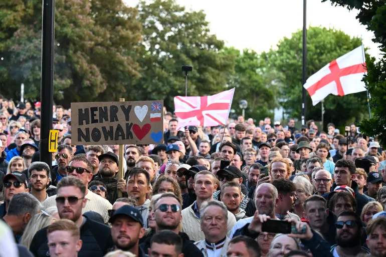 SOUTHAMPTON, ENGLAND - JUNE 02: People attend a protest about the police's handling of the arrest of Henry Nowak at Southampton Central Police Station on June 02, 2026 in Southampton, England. Far-right and nationalist groups have actively organised demonstrations and vigils following revelations from the ongoing murder trial of 18-year-old student Henry Nowak. The case involves the fatal stabbing of Nowak in Southampton in December 2025 by Vickrum Digwa. Court details revealed that Digwa falsely claimed to arriving officers that he was the victim of a racist attack, leading responding police to temporarily handcuff the fatally wounded teenager before discovering his injuries. (Photo by Finnbarr Webster/Getty Images)