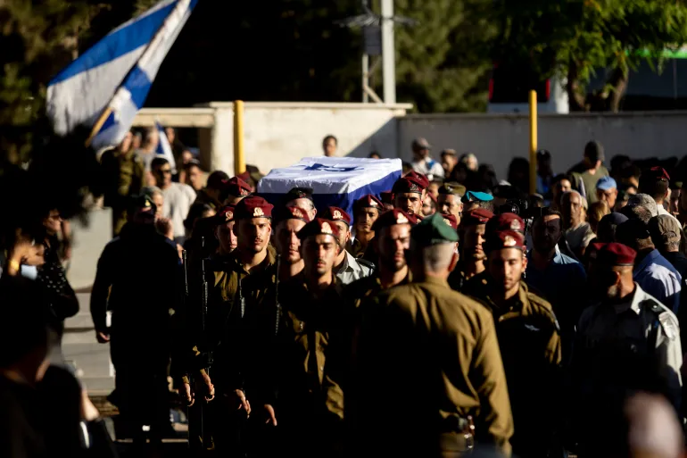 ROSH HAAYIN, ISRAEL - JUNE 1: Israeli soldiers carry a coffin covered with the Israeli flag during a funeral service for Israeli soldier, Staff Sgt. Adam Tzarfati on June 1, 2026 in Rosh HaAyin, Israel. According to the Israeli military, Staff Sgt. Adam Tzarfati was killed overnight by a Hezbollah drone near the southern Lebanon town of Yohmor, near the Beaufort Castle, where Israeli troops were operating. (Photo by Amir Levy/Getty Images)