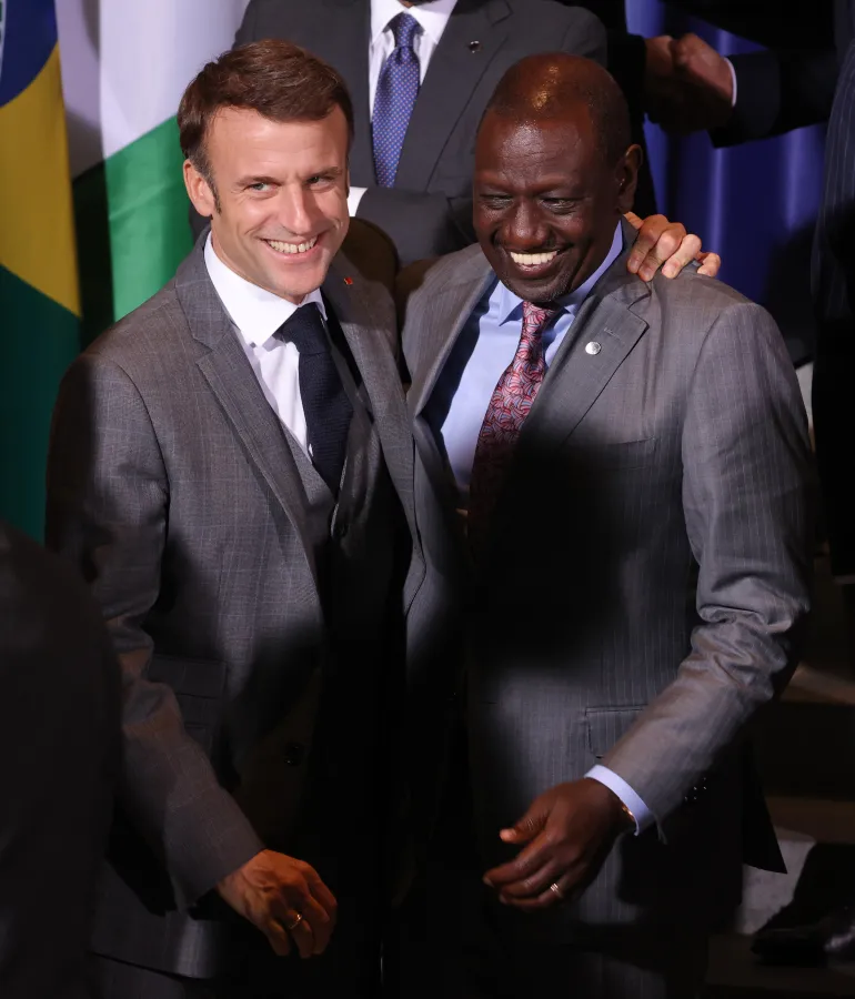 BERLIN, GERMANY - NOVEMBER 20: French President Emmanuel Macron (L) and William Ruto, President of Kenya, share a laugh at the G20 Compact With Africa conference on November 20, 2023 in Berlin, Germany. Compact With Africa is a German initiative to encourage investment in participating African countries. (Photo by Sean Gallup/Getty Images)