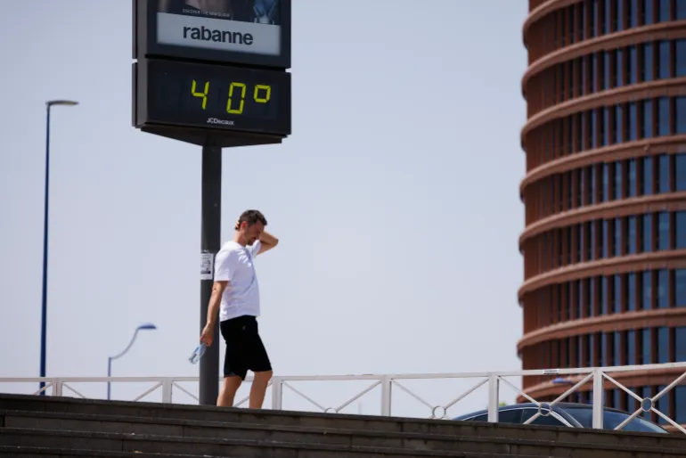 SEVILLE, SPAIN - JUNE 21: A man walks past a thermometer reading 40 degrees Celsius on June 21, 2026 in Seville, Spain. Western Europe is facing its second major heatwave of 2026, driven by a high-pressure system known as a "heat dome" that is drawing hot air from North Africa across the region. Temperatures are forecast to rise above 40°C in some areas. (Photo by Marcelo del Pozo/Getty Images)