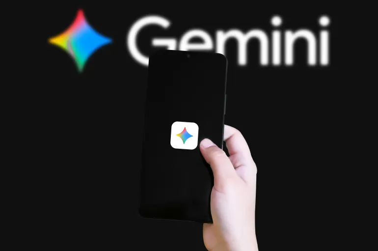 Hand holding smartphone with Gemini app logo in blurred background highlighting cryptocurrency trading platform concept; Shutterstock ID 2754649989; purchase_order: سs; job: s; client: s; other: