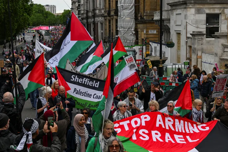People carry Palestinian flags as demonstrators from the Palestine Solidarity Campaign hold a march to mark the 78th anniversary of the Nakba and against the "Unite the Kingdom" rally taking place in London organised by British anti-immigration activist Stephen Yaxley-Lennon, also known as Tommy Robinson, in London, Britain, May 16, 2026. REUTERS/Chris J Ratcliffe